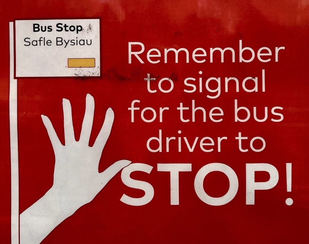 A poster that shows the instructions on how to wave for a bus at bus stop